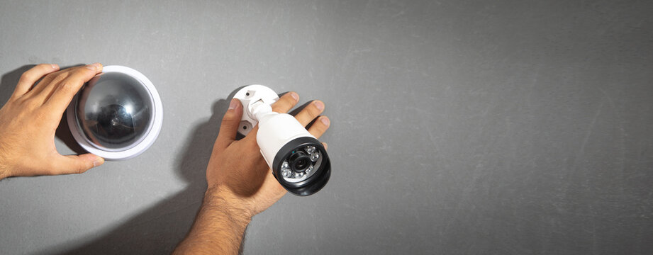 Technician installing CCTV camera system for home.