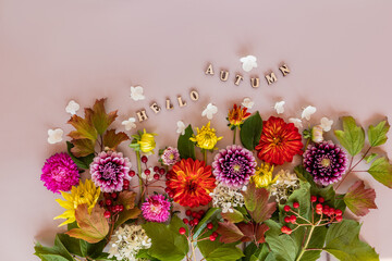 chic autumn composition of bright multi-colored garden flowers and wooden letters with the text -hello autumn. top view. flat lay. beige background.