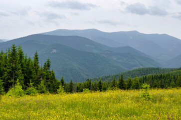 Mountains spring landscape with clouds over the mountains