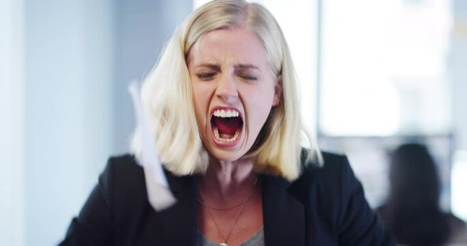 Angry, stress and screaming business woman ripping paper or documents in frustration and irritation in an office. Frustrated, annoyed and upset female corporate employee is overworked and sad
