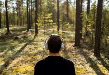 A man meditates listening to calm music with headphones harmony with nature