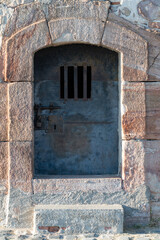Fototapeta na wymiar Old metal security door with bars in Montjuic castle