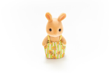 Rabbit doll isolated on white background. Miniature dollhouse toy. Kids toy. Animal doll character. Play and learn. Kids room. Childhood. Kindergarten toy. Developmental toys.

