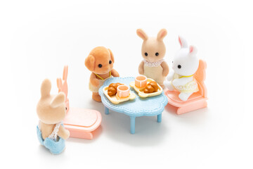 Miniature dollhouse furniture isolated on white background. Animal doll. Kids toy. Play and learn. Kids room. Childhood. Kindergarten toy. Developmental toys. Tiny dining table. Cute doll.
