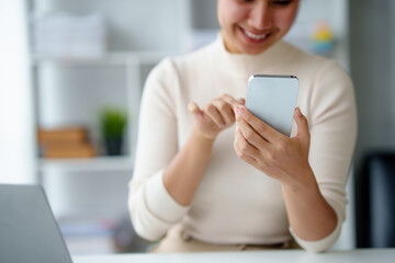 Asian business women are enjoying using smartphone and social media application with pleasure and...