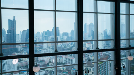 The windows on the skyscrapers are beautiful architecture in the middle of the big city.An office located on a tall building overlooking the sky.