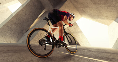 Portrait of man, professional cyclist training, riding on professional sport bike around city on a...