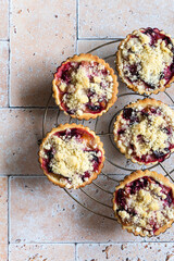 Several home baked plum crumble tarts from above
