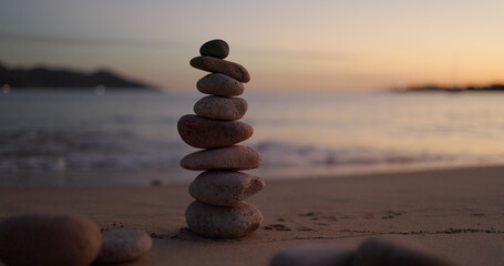 Fototapeta na wymiar Zen stones on the beach at sunset time