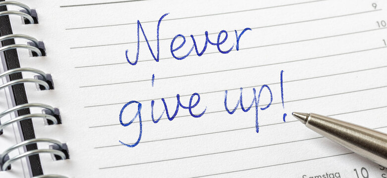 Never give up written on a calendar page