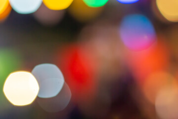 defocused Christmas lights, Bokeh of multi-colored lights in the street at night