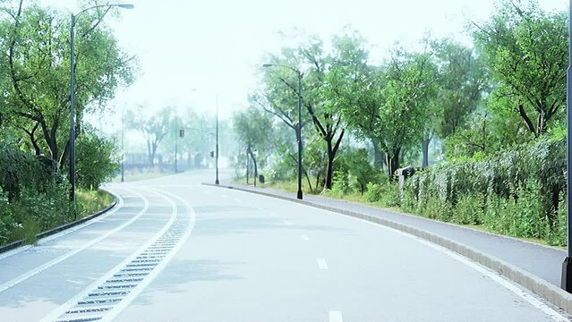 View of empty road with lamp post and sunlight