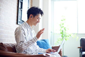 リビングでくつろぐ若い日本人の男性