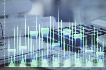 Double exposure of financial chart drawings and desk with open notebook background. Concept of forex market