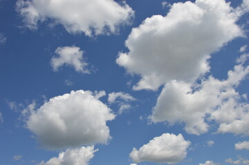 Beautiful whimsical white clouds against the blue daytime sky. Natural background.