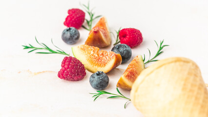 Ice cream cones with berries. Fresh berry fruit, top view of figs, blueberry, raspberry