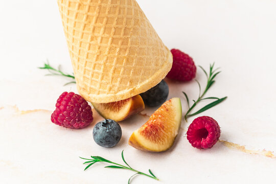 Ice cream cones with berries. Fresh berry fruit, top view of figs, blueberry, raspberry
