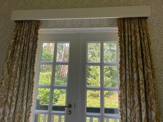 Old fashioned window with beautiful curtains in room. Interior design