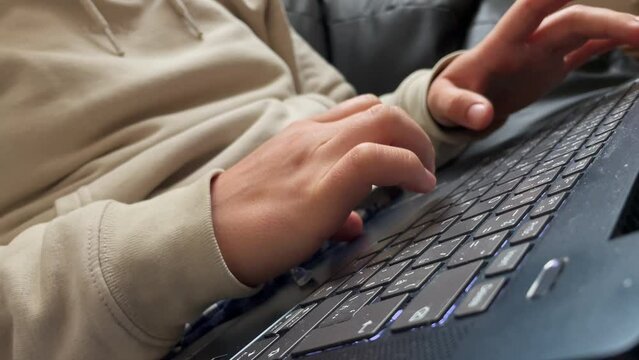 Pressing backspace on laptop keyboard, closeup view of fingers and hands, correcting typing
