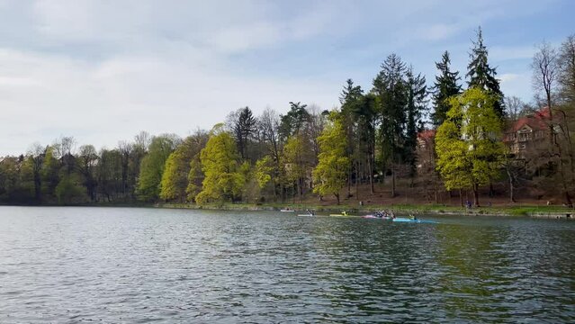 Group of kayakers kayaking on dam or lake in Liberec, Czech Republic, wide angle view, sunny day