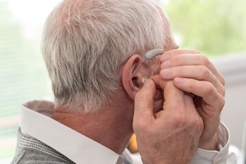 Man putting hearing aids