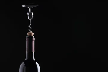 Fotobehang Opening wine bottle with corkscrew on dark background, closeup. Space for text © New Africa