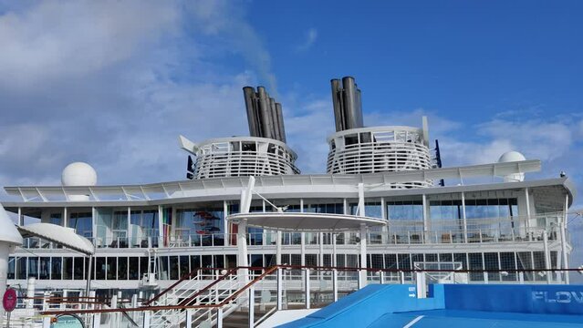 Huge Cruise ship Chimney or smoke funnel with a smoke billowing out in the skies video background | one Smokestack out of two on cruise ship with smoke billowing out into the sky