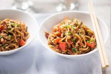 Asian style pasta with minced chicken meat, red pepper and cabbage with chilli sauce 