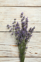 Obraz na płótnie Canvas Beautiful fresh lavender flowers on white wooden background, top view