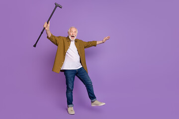 Full size photo of excited grandpa grey hair raise stick recovery wear trendy yellow plaid shirt isolated on lilac purple color background