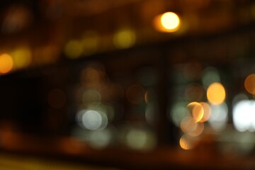 Blurred view of stylish modern bar interior with bokeh effect