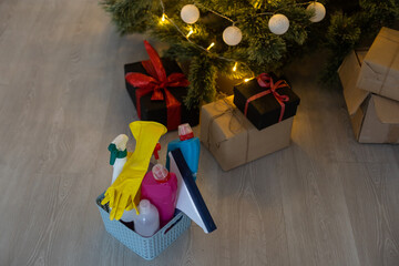 Cleaning before Christmas. Multicolored cleaning supplies. Sponges, rags and spray with festive decorations