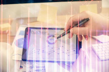 Double exposure of man's hands holding and using a phone and financial chart drawing. Market analysis concept.