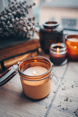 Burning candles on the window, autumn atmospheric photo