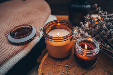 Burning candles, book and lavender, aesthetic autumn photo