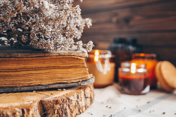 Burning candles, book and lavender, aesthetic autumn photo