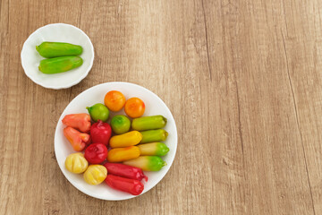Ang Kue (Kue Ku) or Kanom Look Choup, fruit shaped mung beans. Sticky, chewy texture. 
