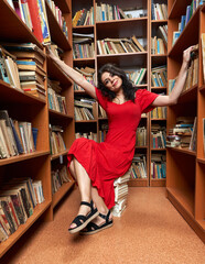 Woman in red dress in a library