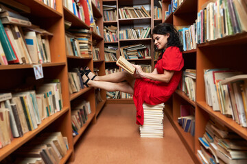 Woman in red dress in a library