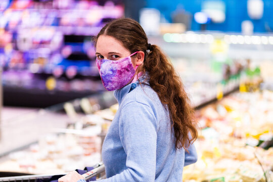 Person Walking Down Grocery Store Aisle Wearing Home Made Face Mask During Covid-19 Pandemic