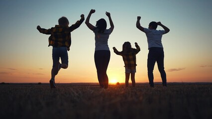 friendly family jumping rejoice. silhouette a happy family bouncing with happiness after victory in nature sunset. happy family kid dream freedom concept. big family happy freedom in nature lifestyle