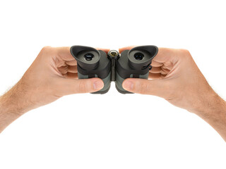 Male hands hold modern compact binoculars, front view from the eyepieces. Search concept. Isolated on white background.