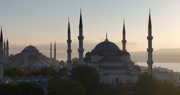 Istanbul, Turkey. Sultanahmet area with the Blue Mosque and the Hagia Sophia with a Golden Horn and Bosphorus bridge in the background at sunrise.