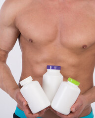 Diet and healthy lifestyle. Young attractive guy with a nice body and sports supplements.