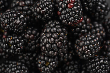 a heap of fresh ripe blackberries in a black plate