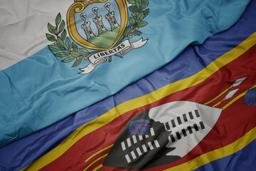 waving colorful flag of swaziland and national flag of san marino.
