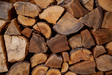 Chopped firewood stacked in rows close-up..