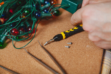 New Years is soon. Repair of Christmas tree electric garland