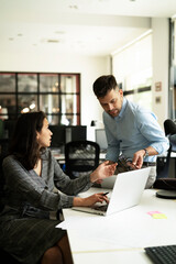 Fototapeta premium Colleagues in office. Businesswoman and businessman discussing work in office..