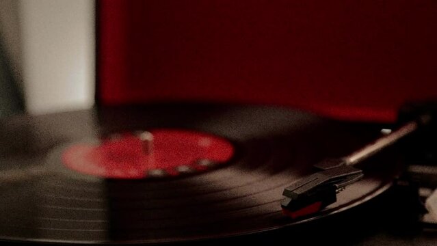 Vinyl record player starting to spin and lay needle down